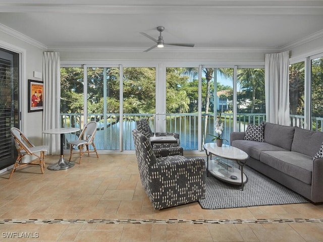 sunroom / solarium featuring a water view and ceiling fan