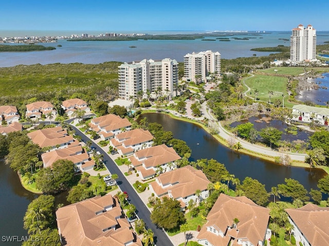 birds eye view of property featuring a water view and a city view