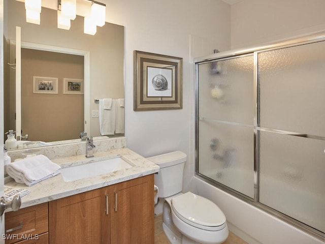 full bath featuring toilet, enclosed tub / shower combo, and vanity