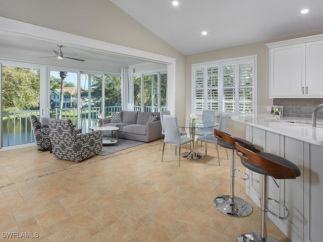 interior space with vaulted ceiling, ceiling fan, and a wealth of natural light