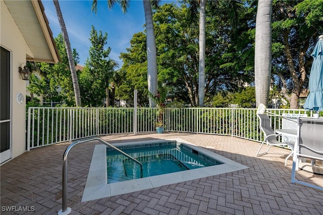 view of pool with a swimming pool, a patio area, and fence