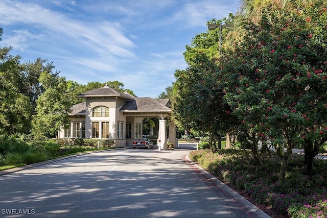 mediterranean / spanish house featuring driveway and stucco siding