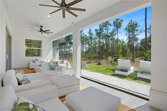 sunroom with ceiling fan