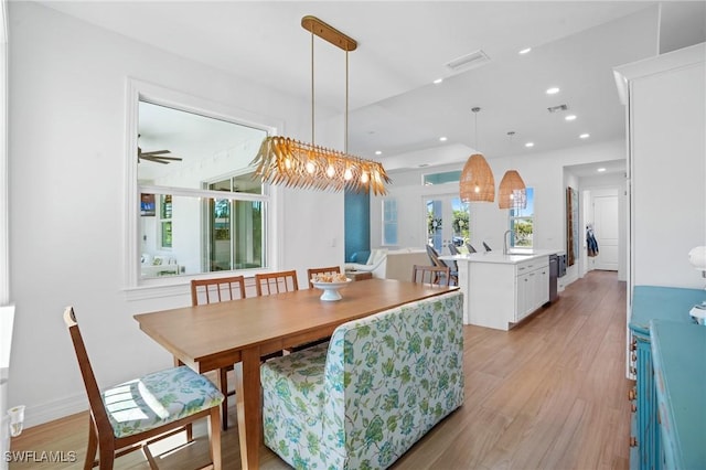 dining area featuring visible vents, light wood-style flooring, and recessed lighting