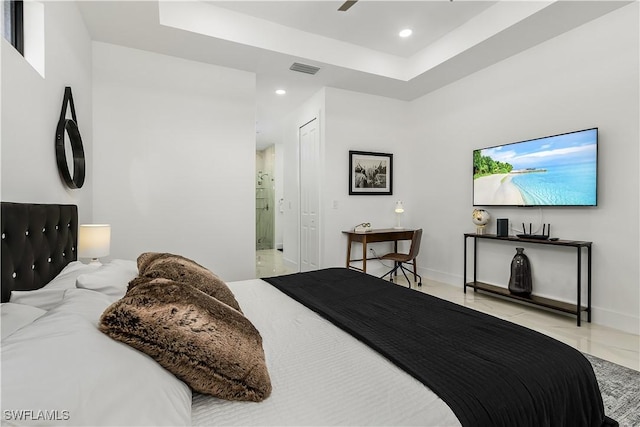 bedroom with visible vents, baseboards, ensuite bath, a tray ceiling, and recessed lighting