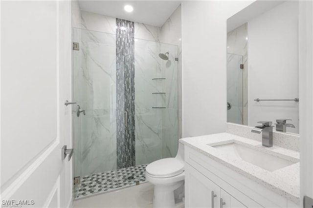 full bath featuring vanity, toilet, and a marble finish shower