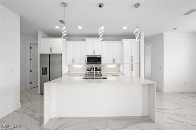 kitchen featuring visible vents, marble finish floor, a kitchen island with sink, a sink, and appliances with stainless steel finishes