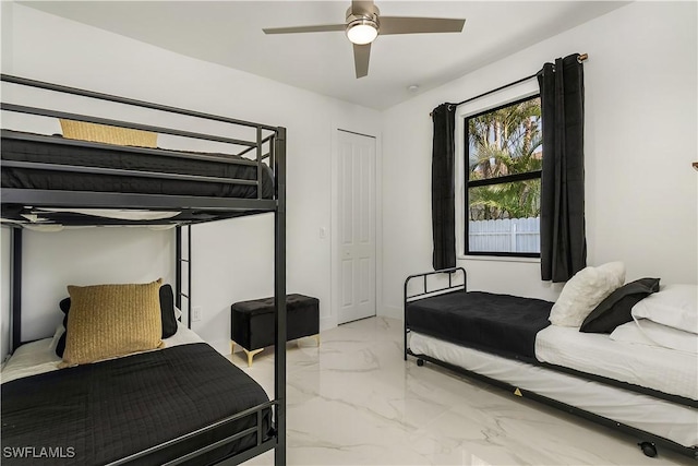 bedroom featuring marble finish floor and a ceiling fan