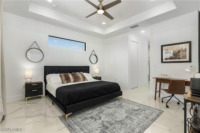 bedroom with a tray ceiling, visible vents, and marble finish floor