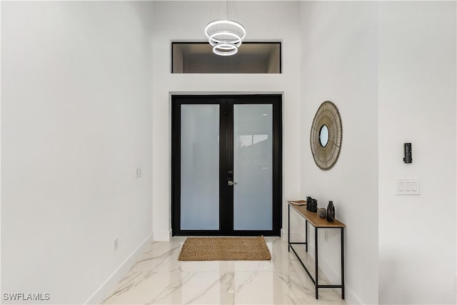 entryway featuring baseboards and marble finish floor