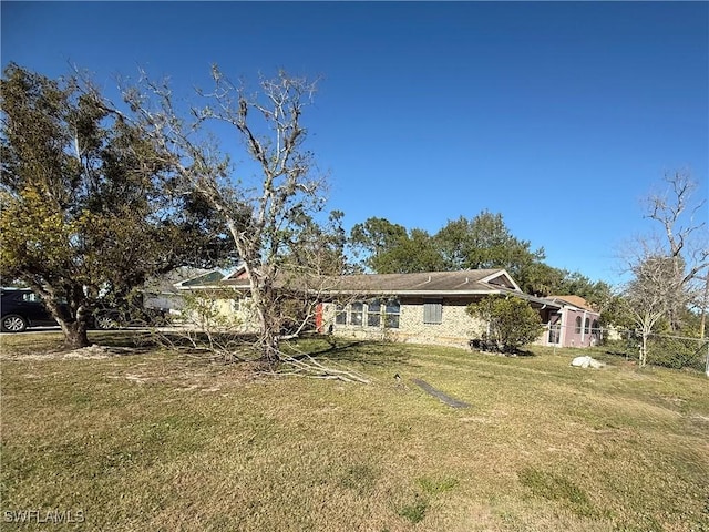 view of front of home with a front yard and fence