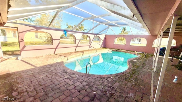 outdoor pool featuring a lanai and a patio area