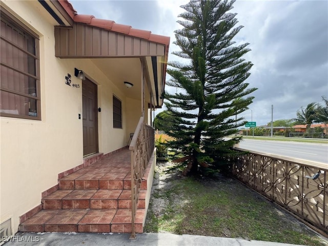 view of exterior entry featuring stucco siding