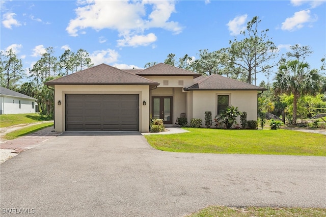 view of front of property with aphalt driveway, stucco siding, french doors, and a front yard