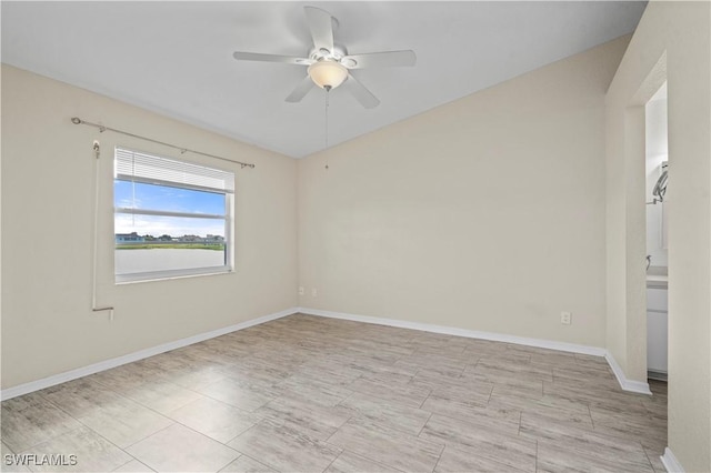 empty room featuring baseboards and a ceiling fan