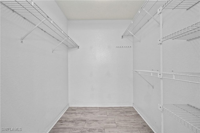 spacious closet with wood finish floors