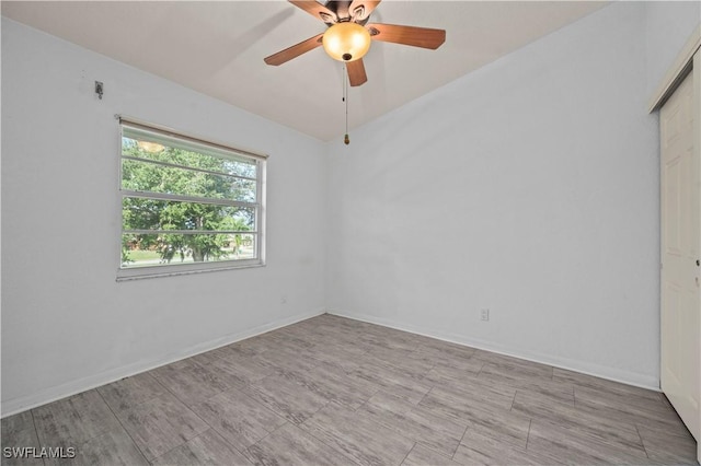 empty room with baseboards and ceiling fan