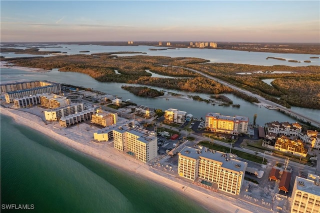 aerial view at dusk with a water view and a city view