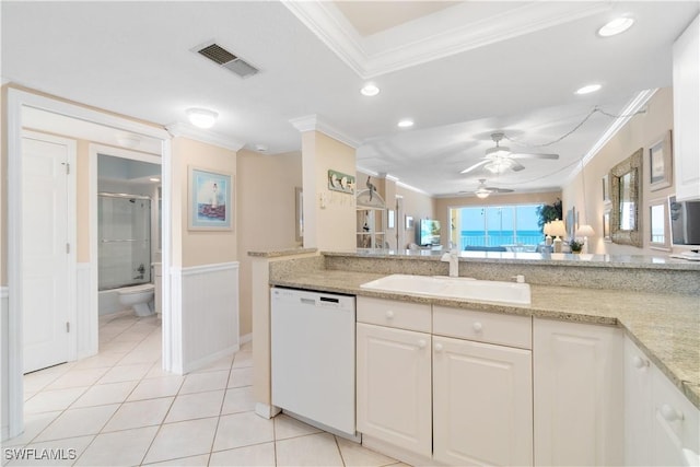 kitchen with visible vents, ornamental molding, a sink, light tile patterned floors, and dishwasher