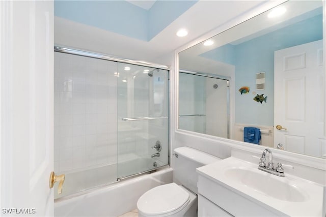 full bath with vanity, toilet, and shower / bath combination with glass door