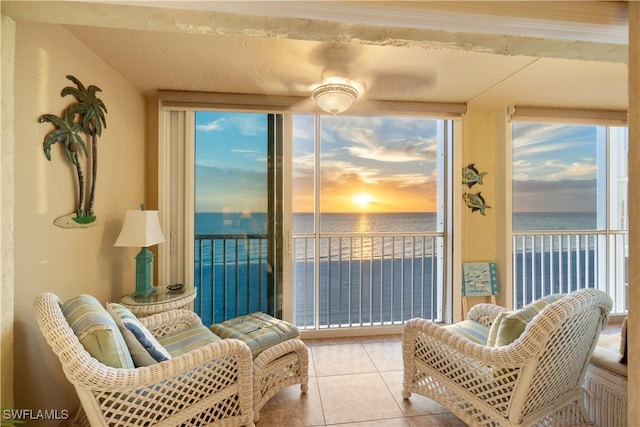 sunroom featuring a wealth of natural light and a water view