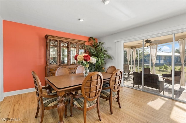 dining area with light wood finished floors and baseboards