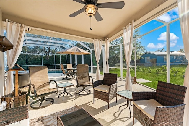 view of patio / terrace featuring a lanai, fence, an outdoor pool, and a ceiling fan