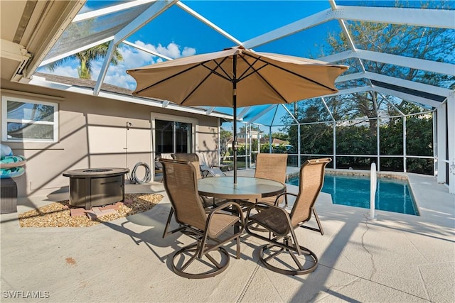 view of patio / terrace with glass enclosure and an outdoor pool