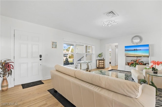 living room with light wood-type flooring and visible vents