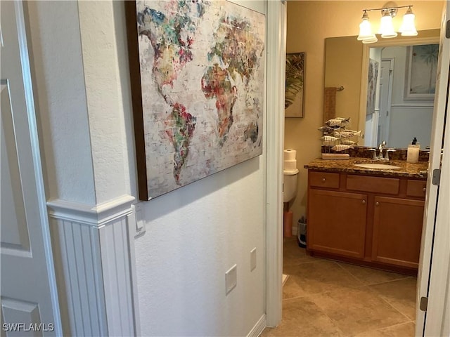 bathroom with vanity, toilet, and tile patterned floors