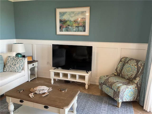 tiled living room with a wainscoted wall and a decorative wall