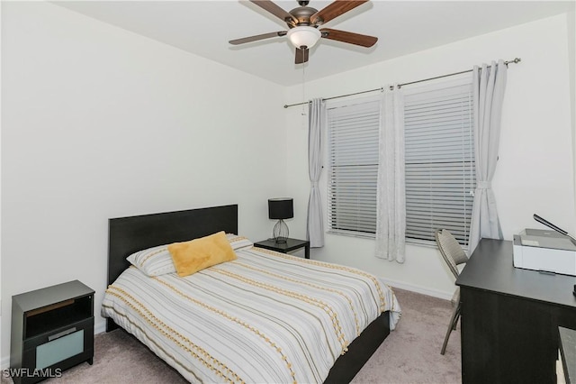 carpeted bedroom with baseboards and ceiling fan