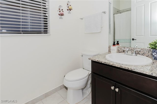 full bathroom featuring tile patterned flooring, toilet, vanity, and baseboards