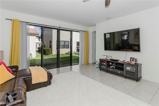 tiled living area with visible vents and a ceiling fan