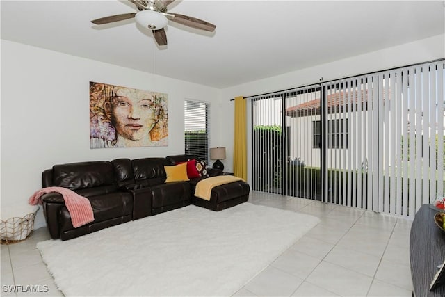 tiled living room with a ceiling fan