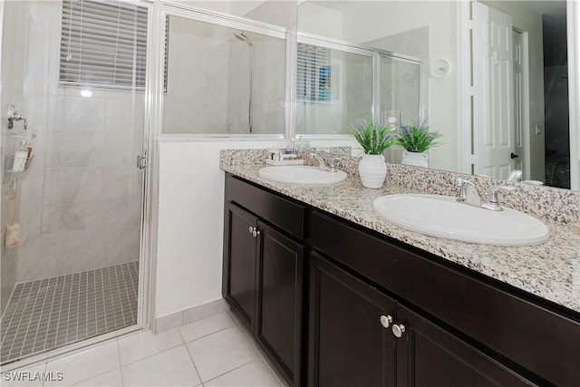 bathroom with a sink, a stall shower, and tile patterned floors