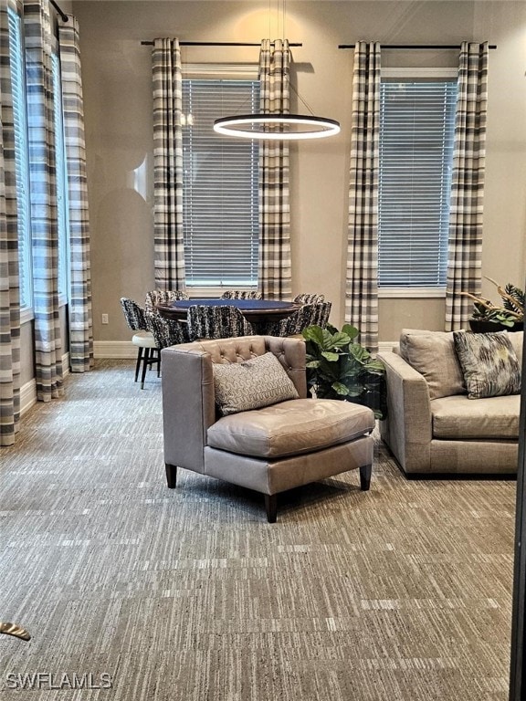 carpeted living area featuring baseboards