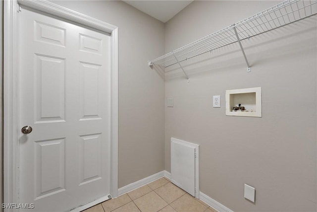 laundry area featuring hookup for a washing machine, baseboards, light tile patterned flooring, and laundry area