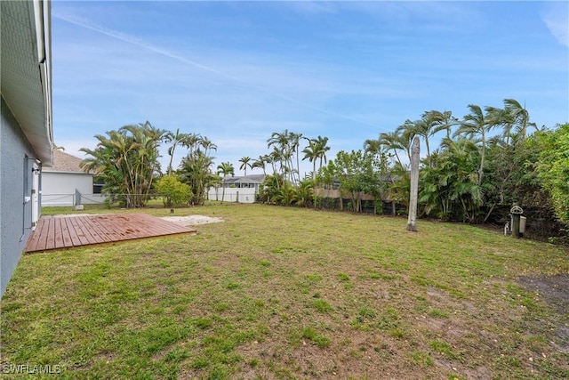 view of yard with a wooden deck and fence