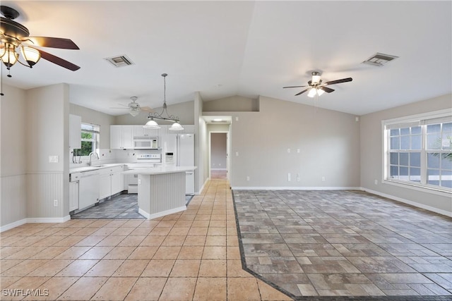 kitchen with open floor plan, white appliances, light countertops, and visible vents