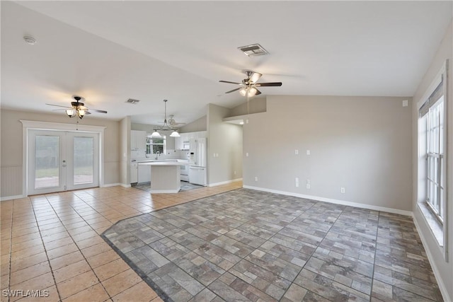 unfurnished living room with lofted ceiling, french doors, visible vents, and ceiling fan