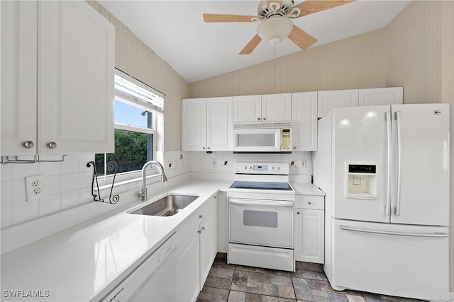 kitchen with white appliances, white cabinetry, light countertops, and a sink