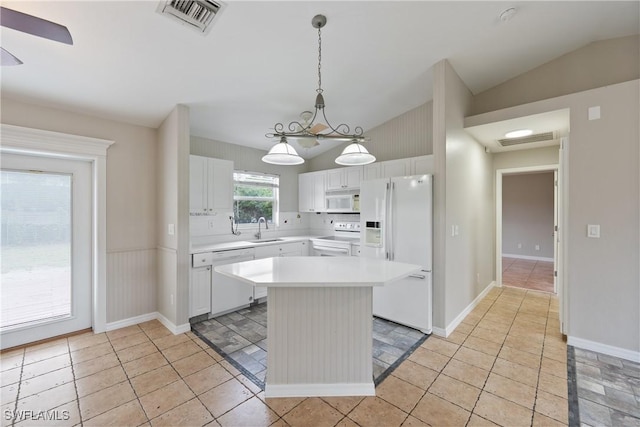 kitchen featuring white appliances, visible vents, lofted ceiling, a sink, and light countertops