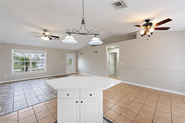 kitchen with visible vents, open floor plan, white cabinets, and hanging light fixtures