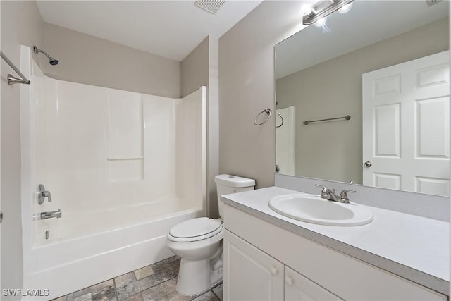 full bathroom featuring visible vents, tub / shower combination, toilet, stone finish floor, and vanity