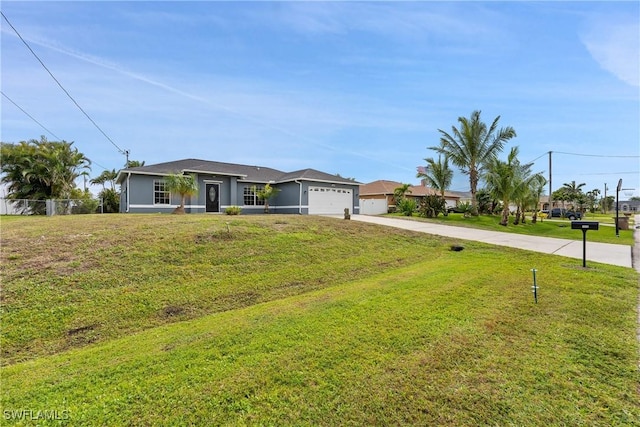 view of front facade with an attached garage, concrete driveway, and a front lawn