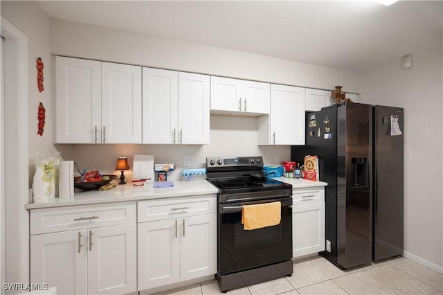 kitchen featuring light tile patterned floors, white cabinetry, black appliances, and light countertops