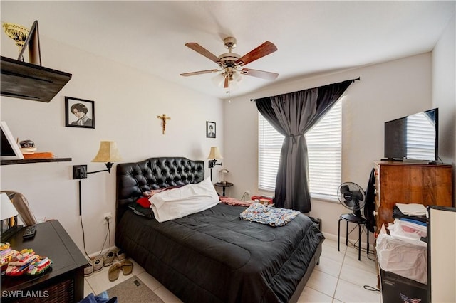 tiled bedroom featuring baseboards and a ceiling fan