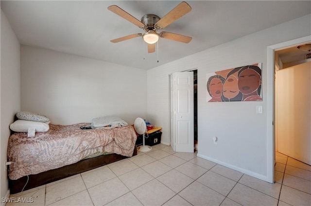 bedroom with light tile patterned flooring, ceiling fan, and baseboards