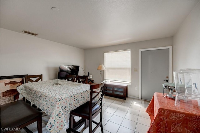 dining space featuring visible vents and light tile patterned flooring